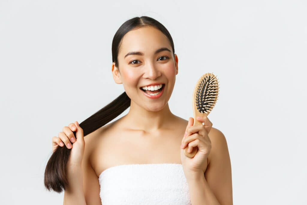 Beauty, hair loss products, shampoo and hair care concept. Beautiful young asian woman in bath towel
